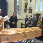 Fr McCabe blesses Fr Toms remains